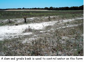 A dam and grade bank is used to control water on the farm